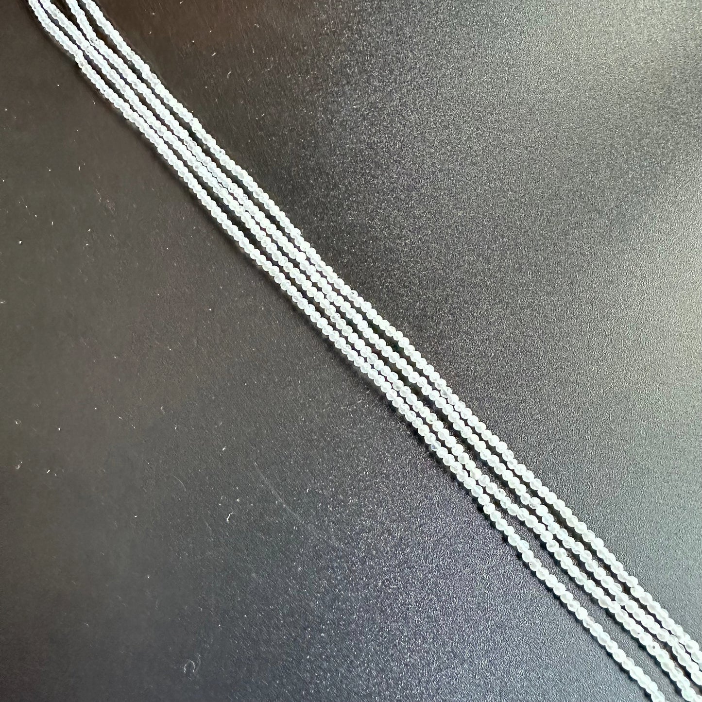White Rainbow Moonstone faceted rondelle beads shimmer softly, elegantly arranged on a 31cm strand.