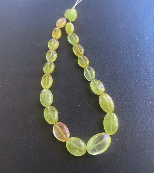 Close-up of Yellow Sapphire gemstones showing polished oval cut and vibrant colour clarity.