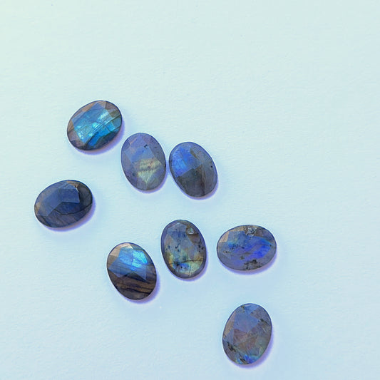 Close-up of 16.3 x 12.3mm Labradorite stone cabochon highlighting iridescent sheen ideal for natural gemstone beads for DIY jewellery.