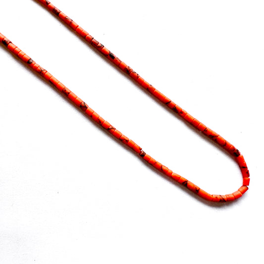 Tube-shaped Afghan gemstone beads arranged in soft earthen hues on a 31cm strand.