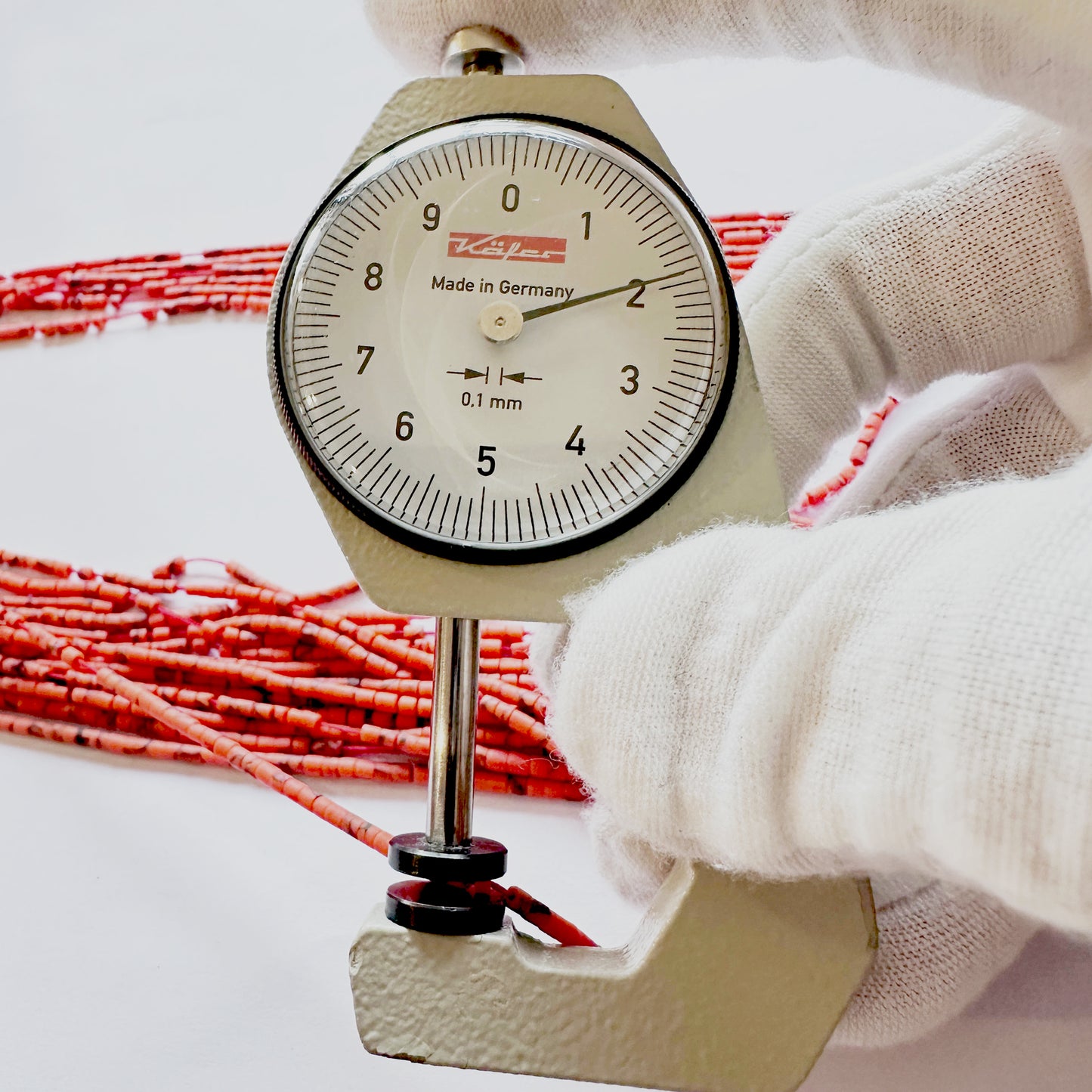 A dial gauge measures the Afghan tube cut 1.9–2.2mm gemstone.