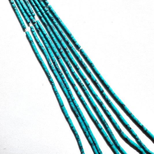 Afghan Heishi beads arranged in a neat strand with subtle colour and refined shape.