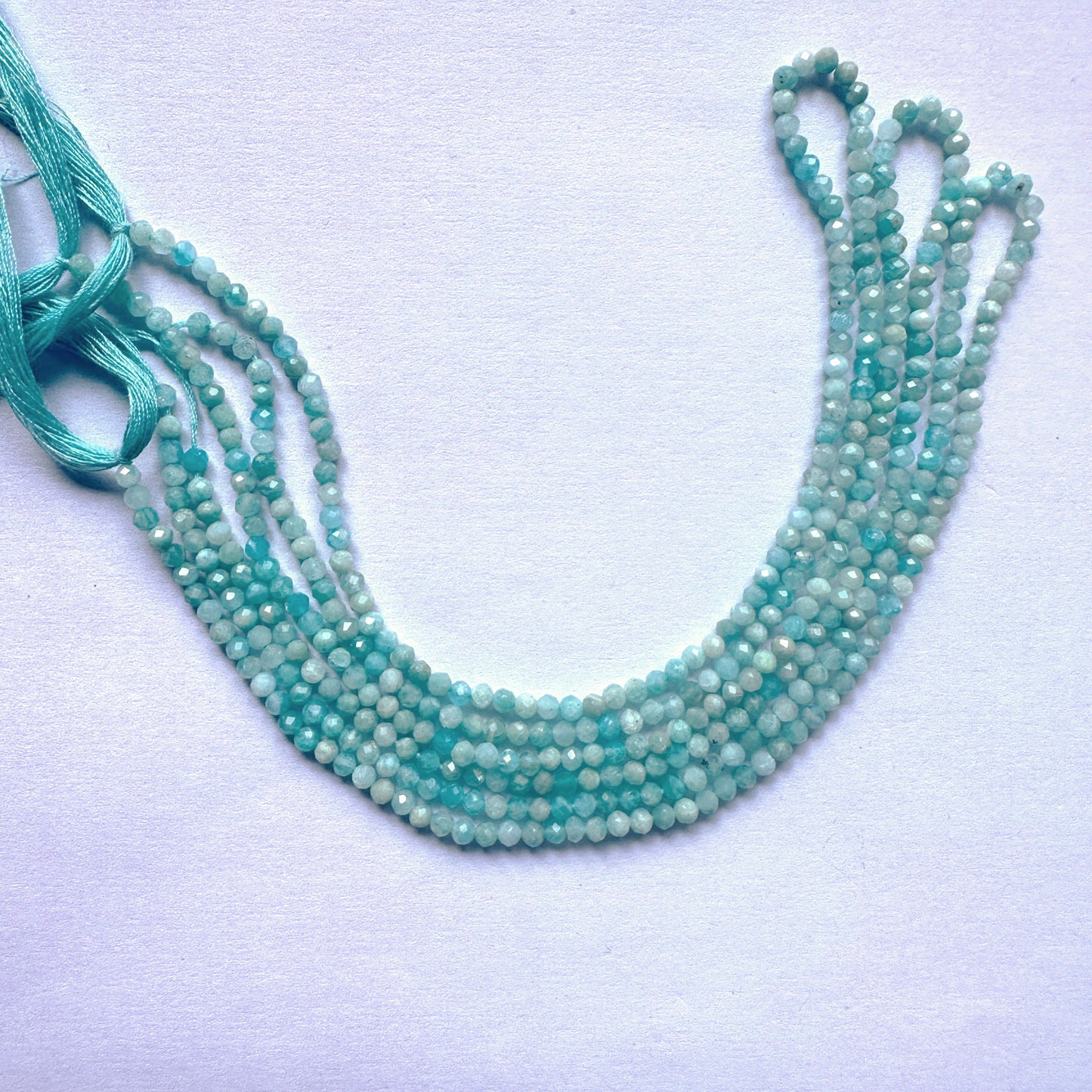 Delicate strands of Amazonite beads showcasing their Rondelle design.