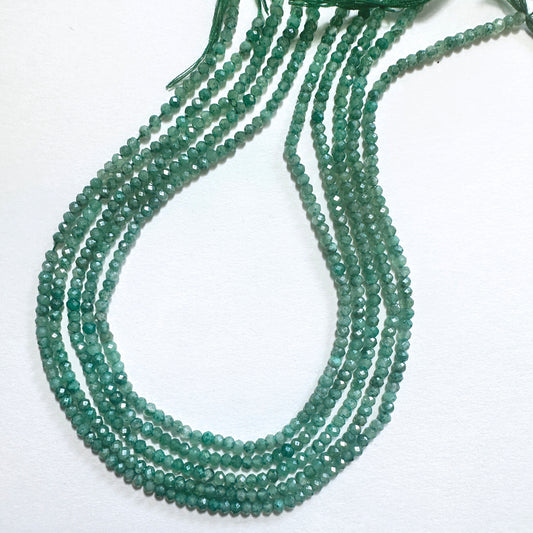 Green faceted rondelle stone beads with a glossy finish, ideal for handmade jewellery components.