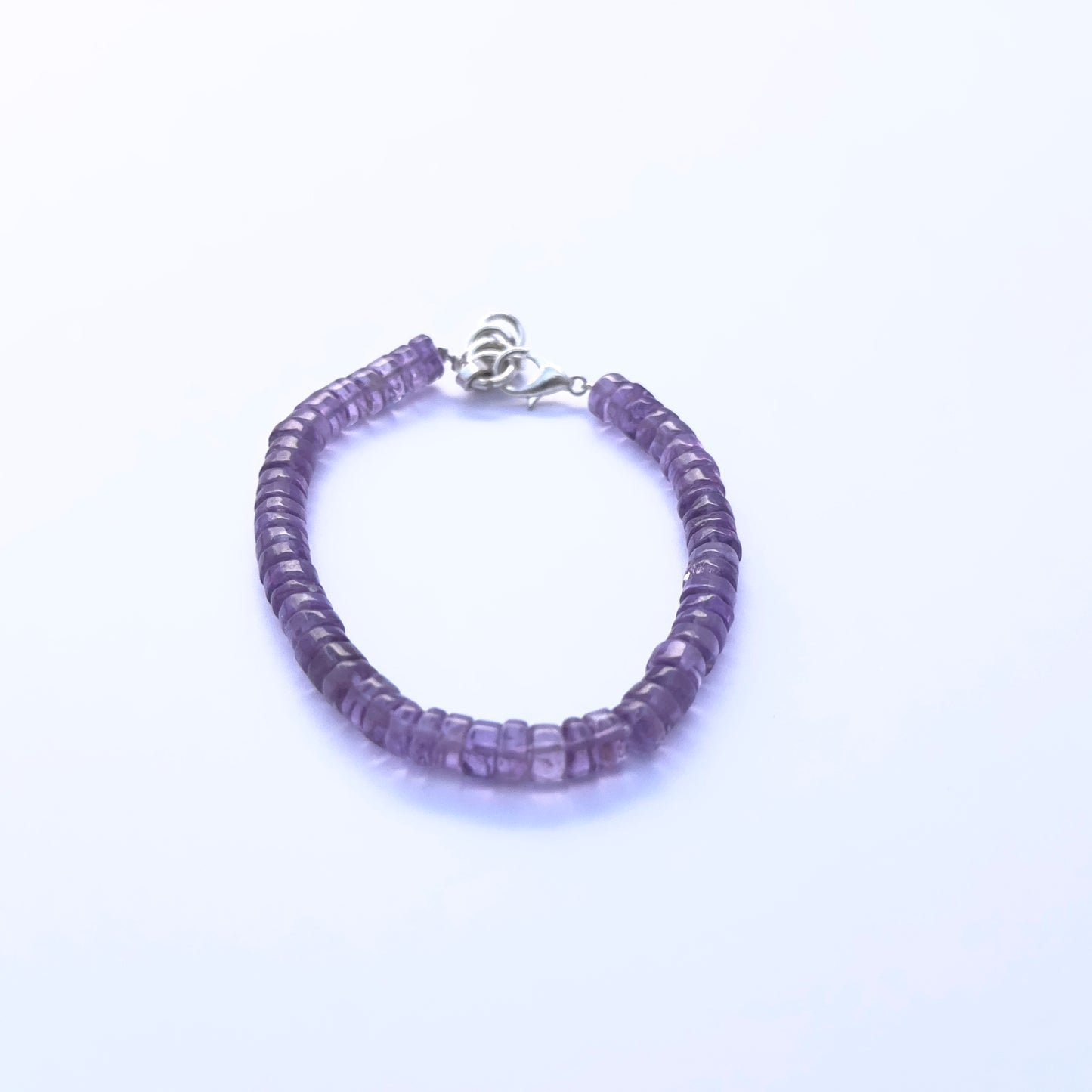 Natural gemstone beads in rich violet amethyst, styled into a sleek adjustable bracelet.