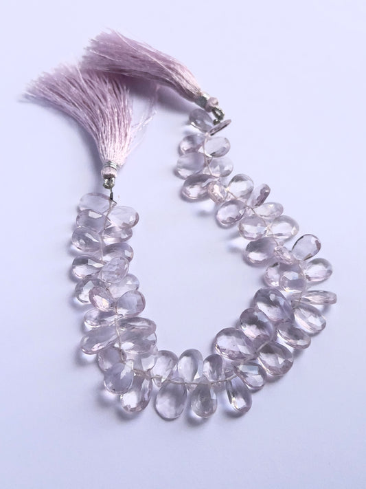 Stone beads in a strand of Amethyst, highlighting their polished facets and 7.5–8.5mm size.