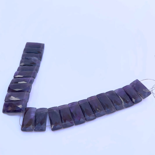 Close-up of Amethyst gemstone beads showing faceted cut and polished surface.