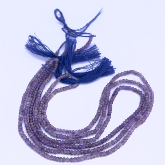 Natural Amethyst stone beads arranged in strands with vibrant purple shimmer.