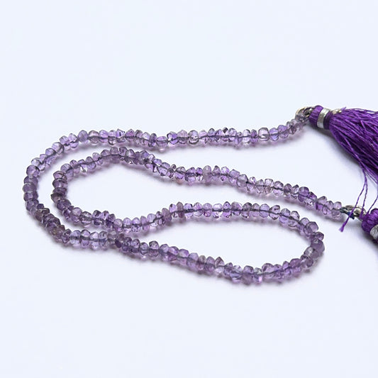 Close‑up of Amethyst stone beads in faceted rondelle cut, highlighting shine and clarity for handmade jewellery components.