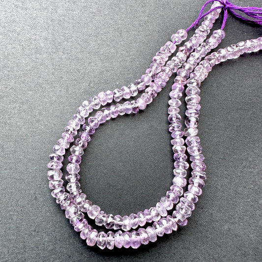 Close-up of Amethyst stone beads showing faceted cut and natural gemstone sparkle.