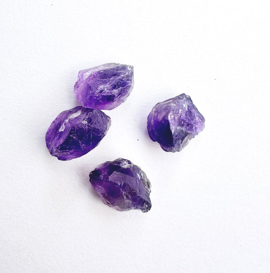 Amethyst rough undrilled stones in deep purple tones, 4 pieces, arranged for jewellery making.