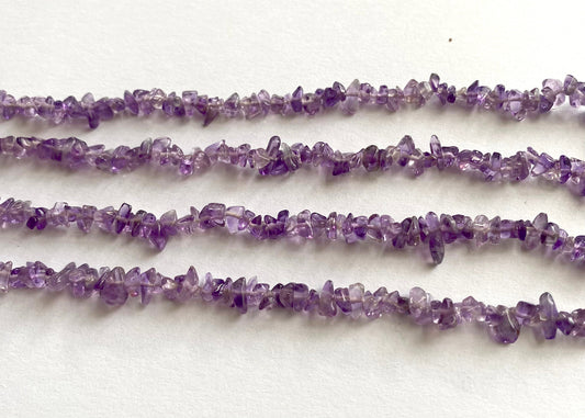 Glossy Amethyst chips threaded on a 44cm strand for jewellery making.