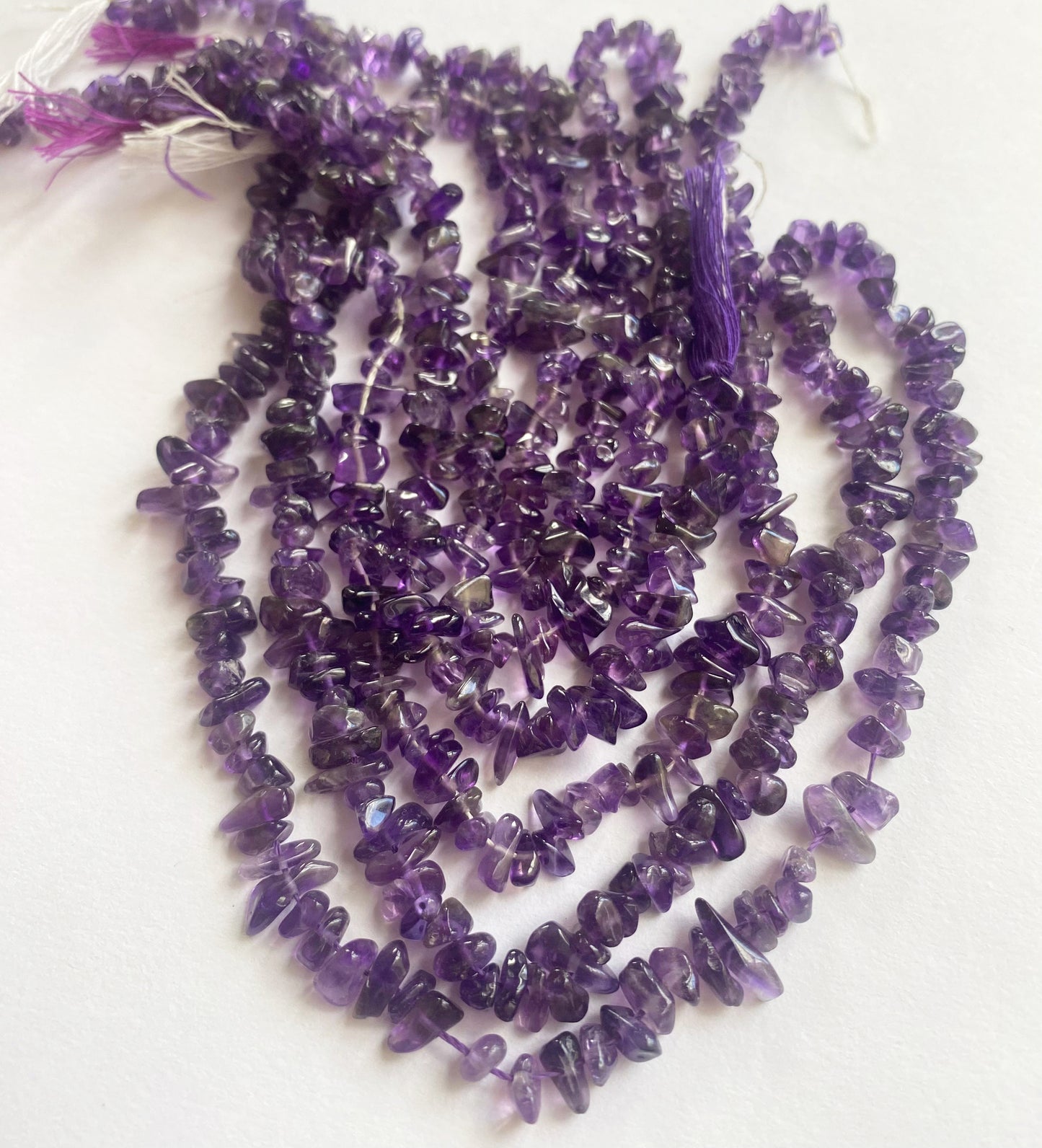 Strand of Amethyst chip beads with rich purple colour and natural surface texture.