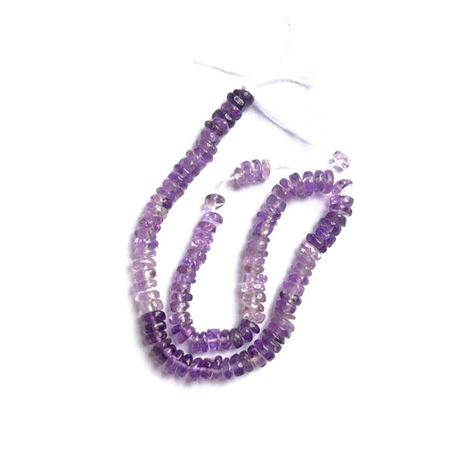 Close-up of amethyst smooth heishi beads highlighting their even shape and natural gemstone colour.