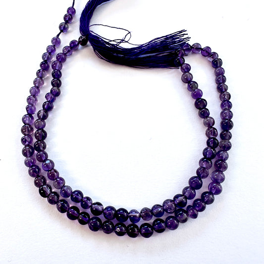 Natural gemstone beads in Amethyst, arranged on a 33cm strand with consistent polish.