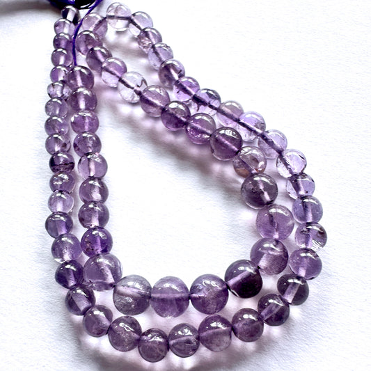 Stone beads with smooth Amethyst arranged neatly, ideal for handmade jewellery components.