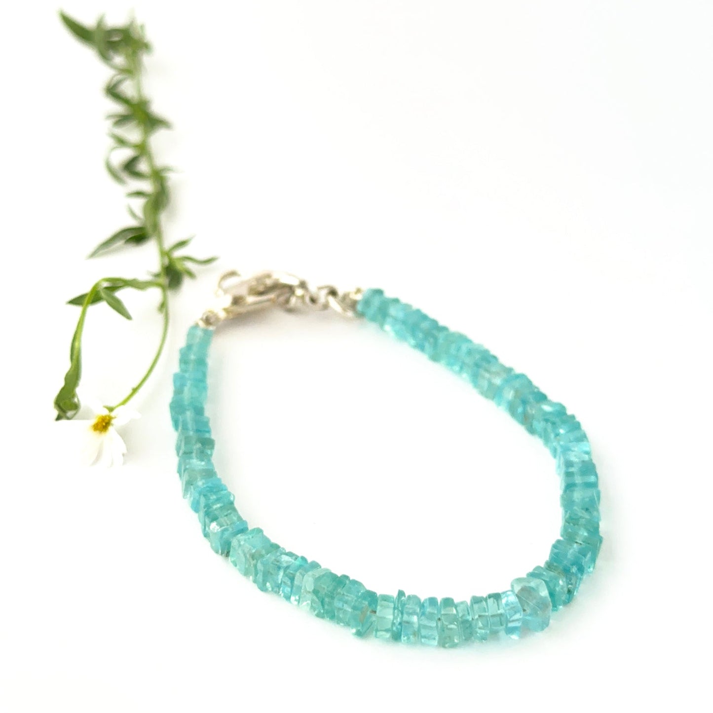 Apatite bracelet made with square heishi beads arranged in a single adjustable strand.