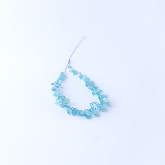 Authentic Apatite rough gemstone beads displaying vivid blue tones and organic uncut texture.