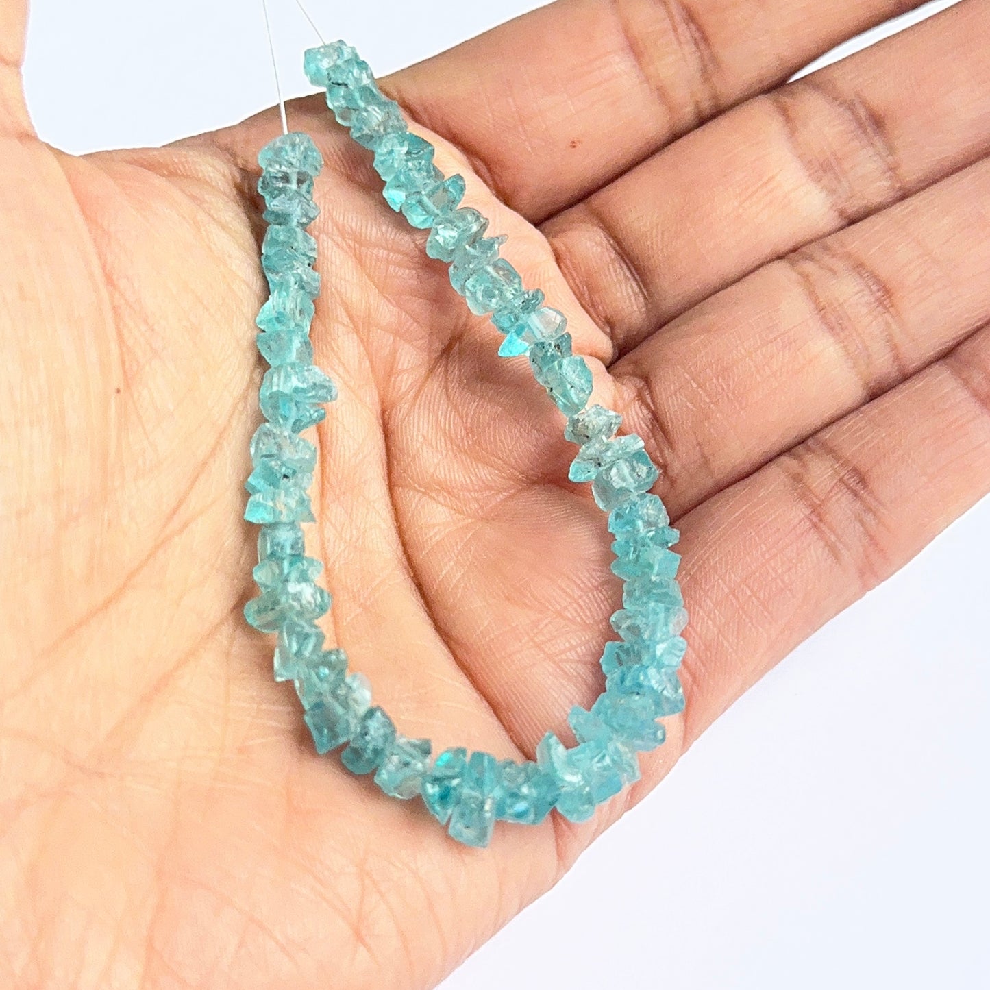 Raw apatite stones displayed with visible texture ideal for natural gemstone beads in jewellery making.