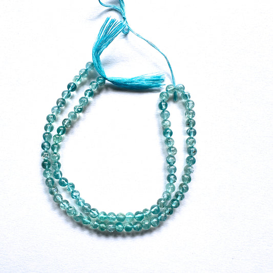 Stone beads with smooth Apatite arranged neatly, ideal for handmade jewellery components.