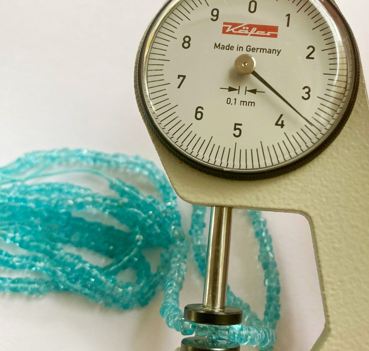 Vibrant Apatite smooth wheel beads 3.5mm with a polished finish arranged in a 16cm strand for jewellery making.