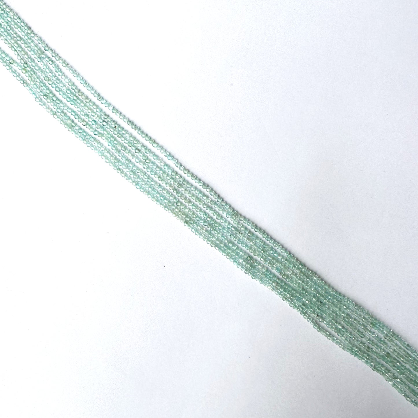 Aquamarine faceted rondelle beads in 1.9–2.0mm size with subtle blue colour and glistening finish.