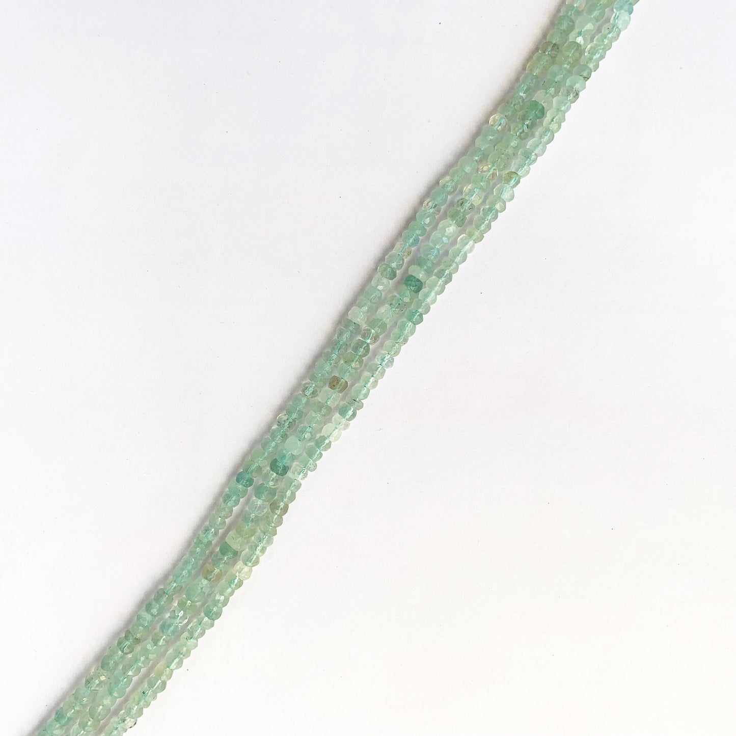 Strand of 31cm Aquamarine rondelle beads arranged in gradient blue hues with polished shine.