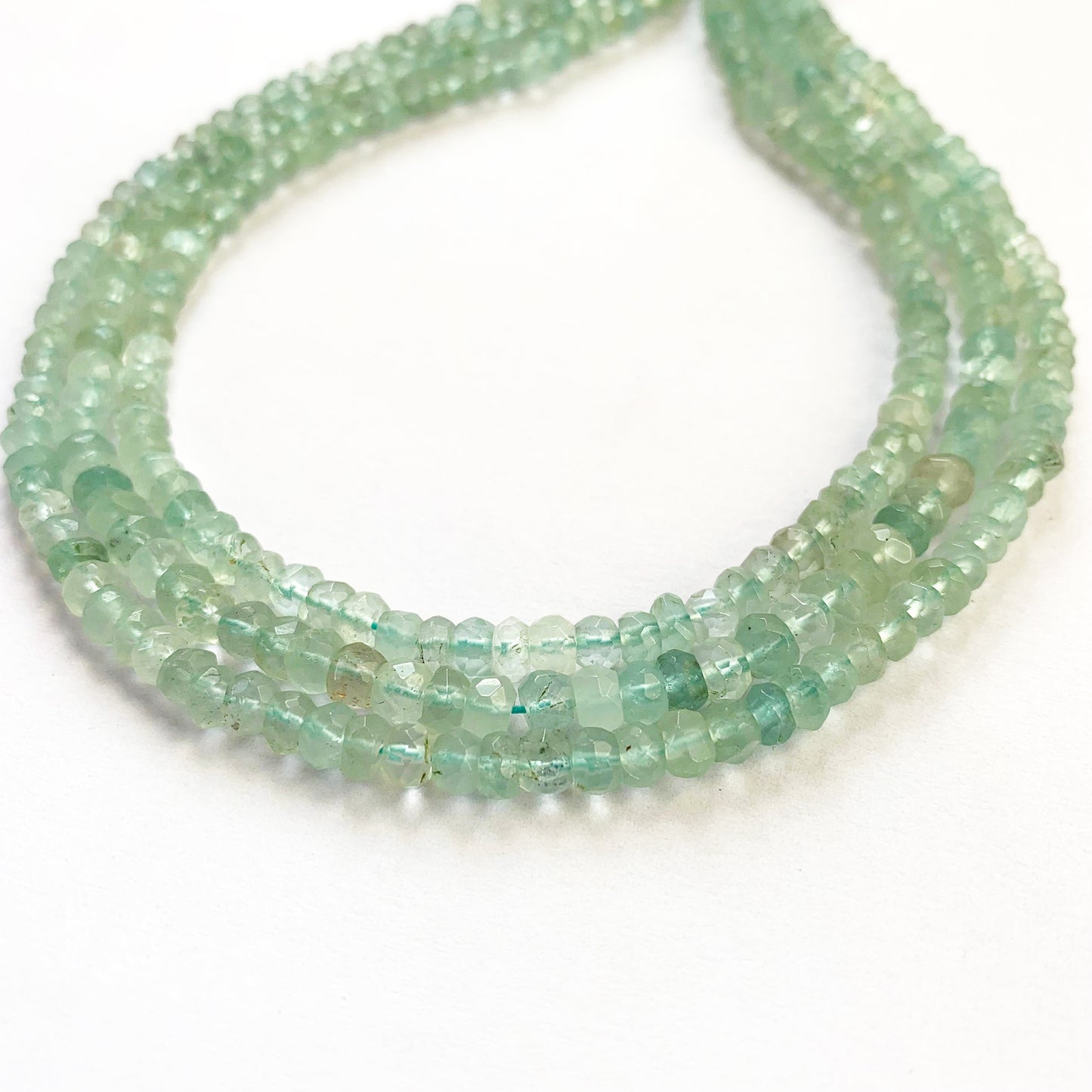 Artisan-crafted Aquamarine beads in rondelle shape displaying high brilliance and even texture.