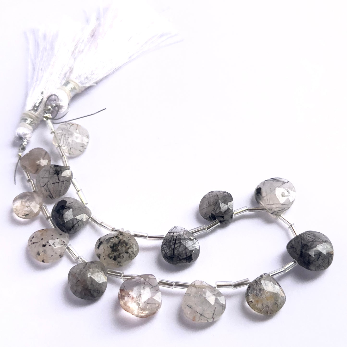 Stone beads in a strand of Black Rutile, highlighting their polished facets and 9.5–12.7mm size.