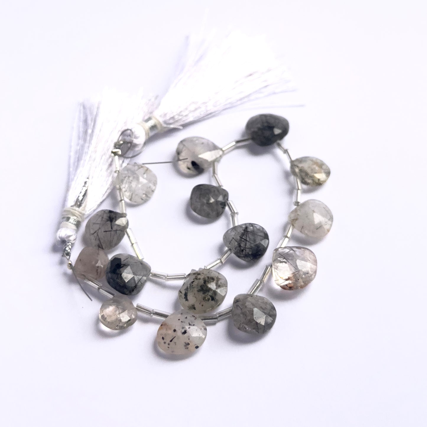 Handmade jewellery components featuring Black Rutile faceted briolette beads strung neatly together.