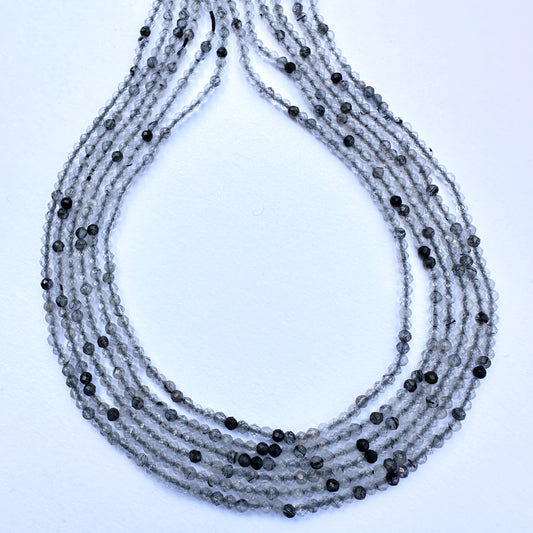 Natural gemstone beads in black rutile with precision faceting and consistent arrangement on a 32cm strand.
