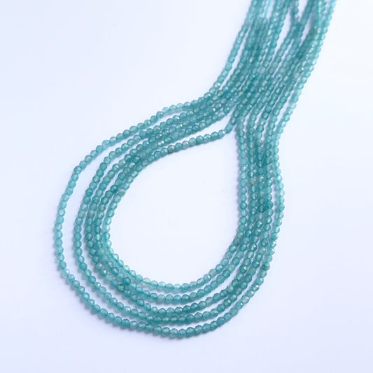 Close-up of natural gemstone beads showing the faceted rondelle cut and delicate sparkle.