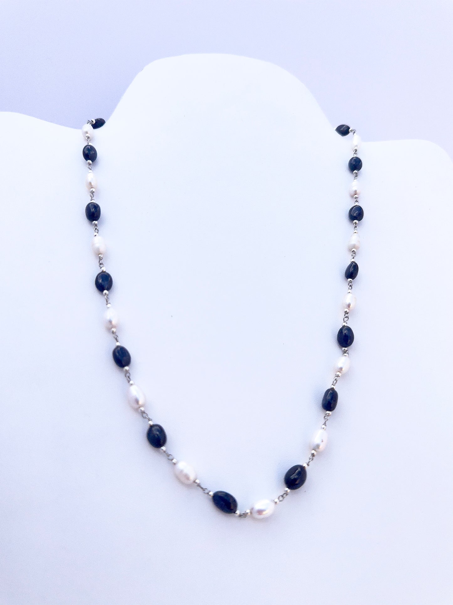 Handmade jewellery components in a Sapphire and Pearl necklace with refined oval cut and lustrous shine.