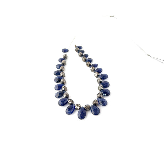 Blue Sapphire faceted briolette gemstones with glossy surfaces and crisp teardrop faceting in a 6–7.5mm size range.