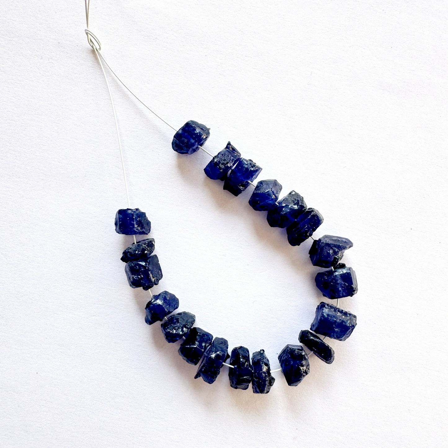 High-quality Blue Sapphire rough beads with visible surface texture and rich hue.