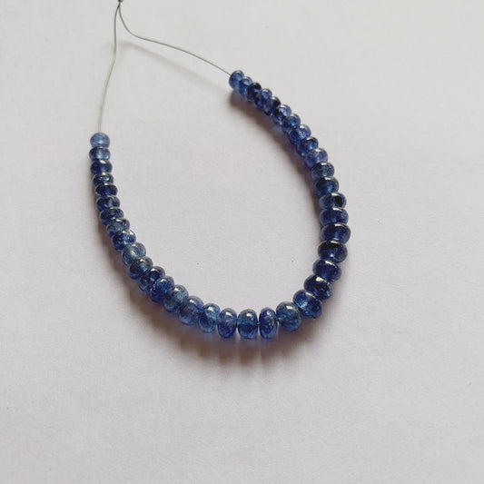 Close-up of smooth Blue Sapphire rondelle gemstones with polished finish and deep colour saturation.