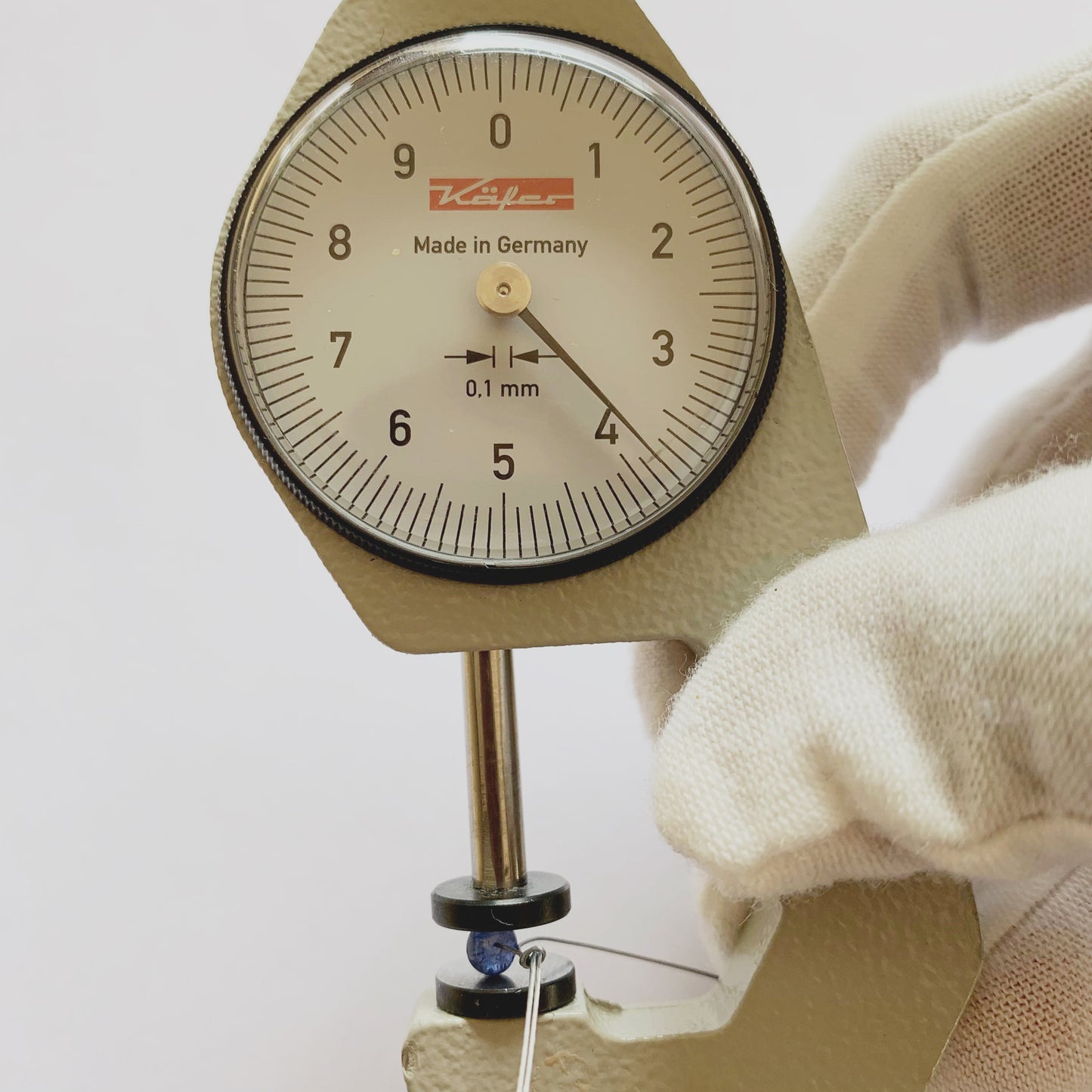 A dial gauge measures the Blue Sapphire rondelle 3.8mm gemstone.