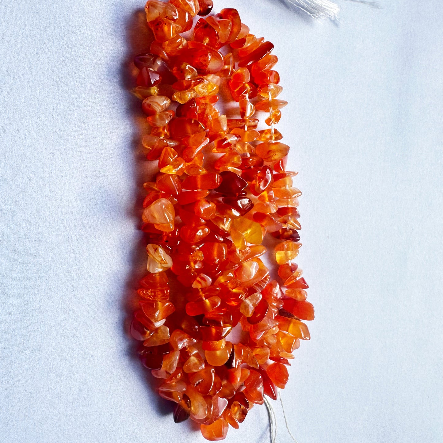 Strands of 5-8mm Carnelian chips display a bold mix of natural shapes and fiery tones.