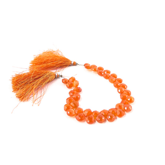 Handmade jewellery components featuring Carnelian briolette beads, offering rich orange hues and elegant faceted detailing.