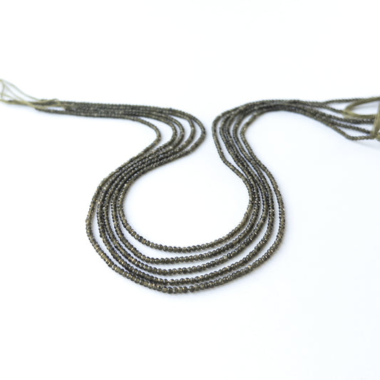 Cat's Eye faceted rondelle gemstone beads in 2mm size arranged on a 33cm strand with soft reflective shine.