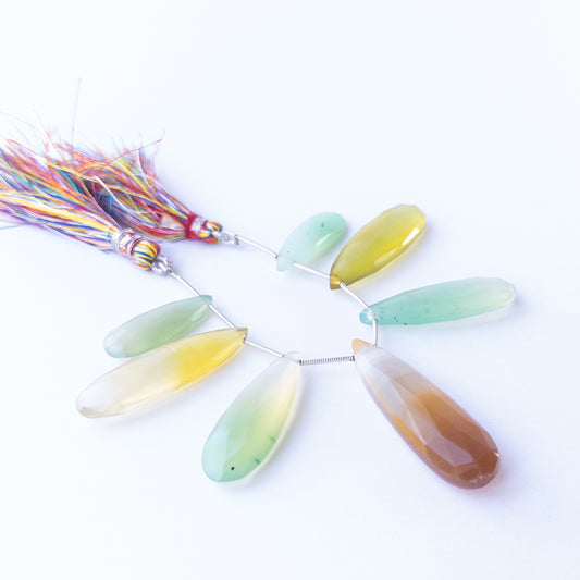 Natural Chalcedony faceted briolette stones displaying soft grey‑blue tones and elongated teardrop shapes.