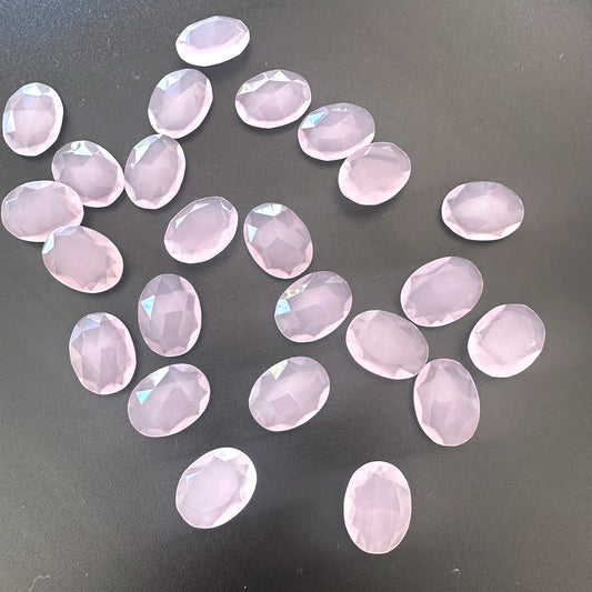 Close-up of Chalcedony gemstones showing faceted oval cut and translucent pastel tones.