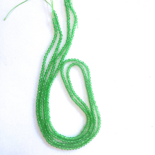 Close-up of chalcedony rondelle beads showing soft translucence and precise faceting.