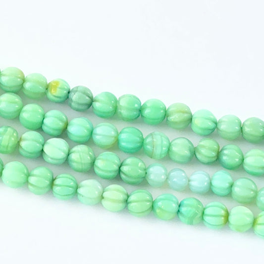 Carved Chalcedony gemstone beads showing soft translucence and pumpkin-cut texture