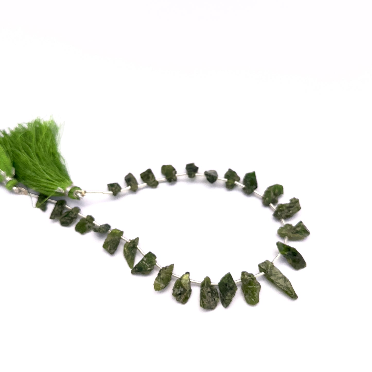 Chrome Diopside gemstone beads for jewellery making displayed with soft lighting.