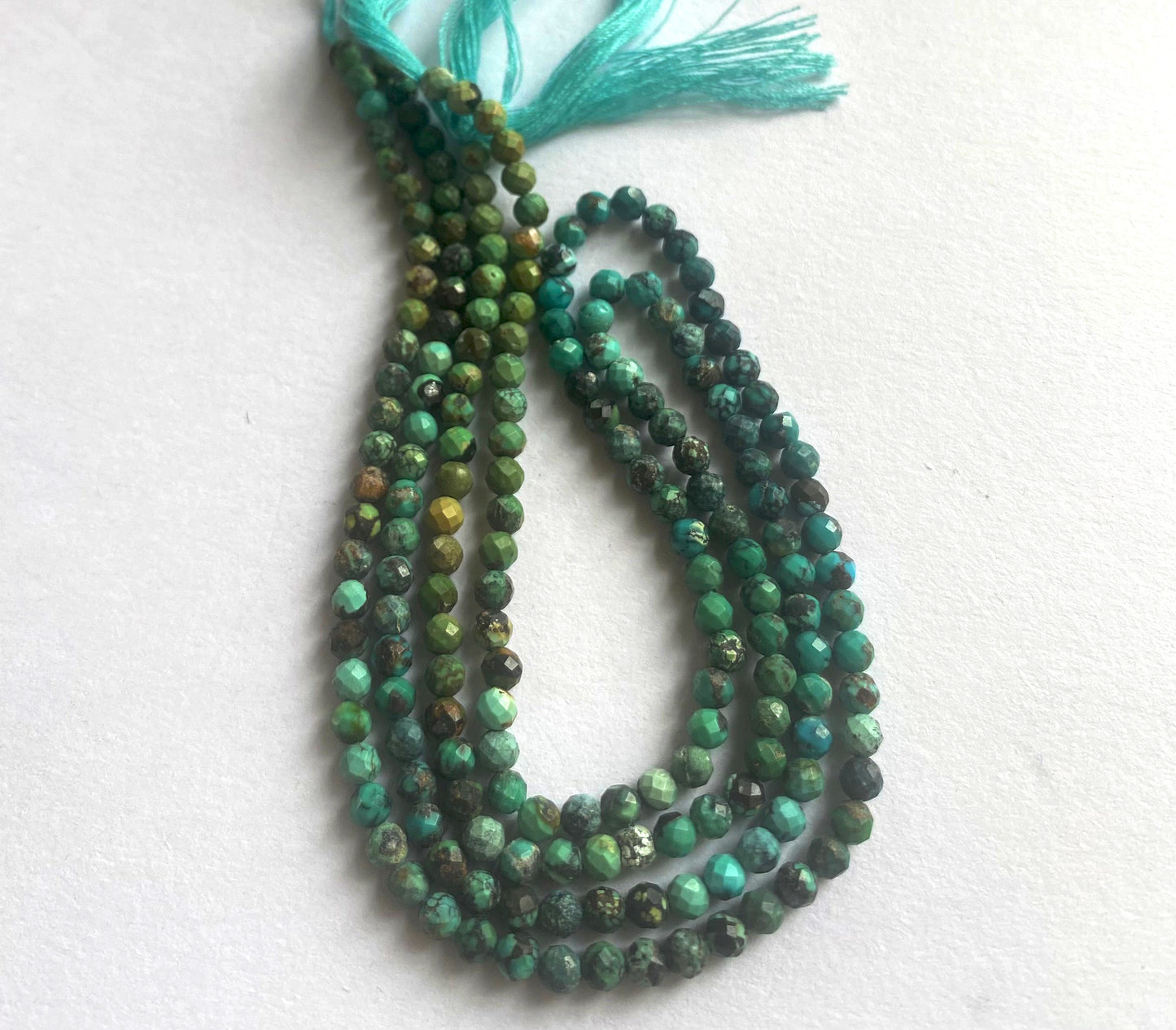 Chrysocolla rondelle beads in 3.5mm size with faceted finish and striking blue-green colour tones.