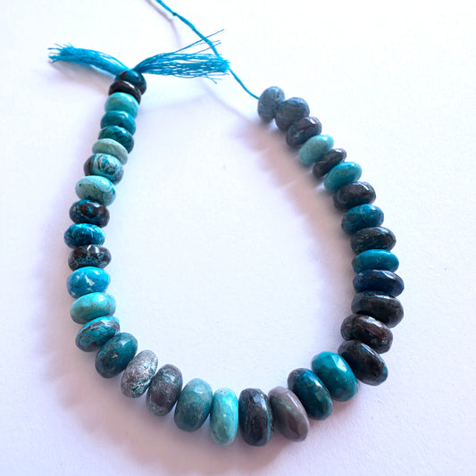 Close-up of Chrysocolla stone beads showing smooth finish and natural colour variations.