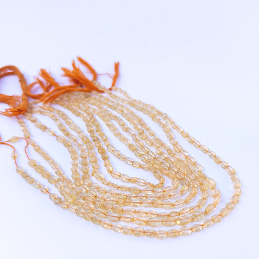 Close‑up of genuine citrine faceted oval gemstone beads with bright sparkle for DIY jewellery making.