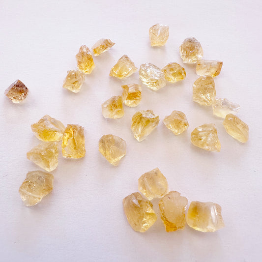Close-up of raw Citrine pieces showing organic surfaces and vibrant colour variation.