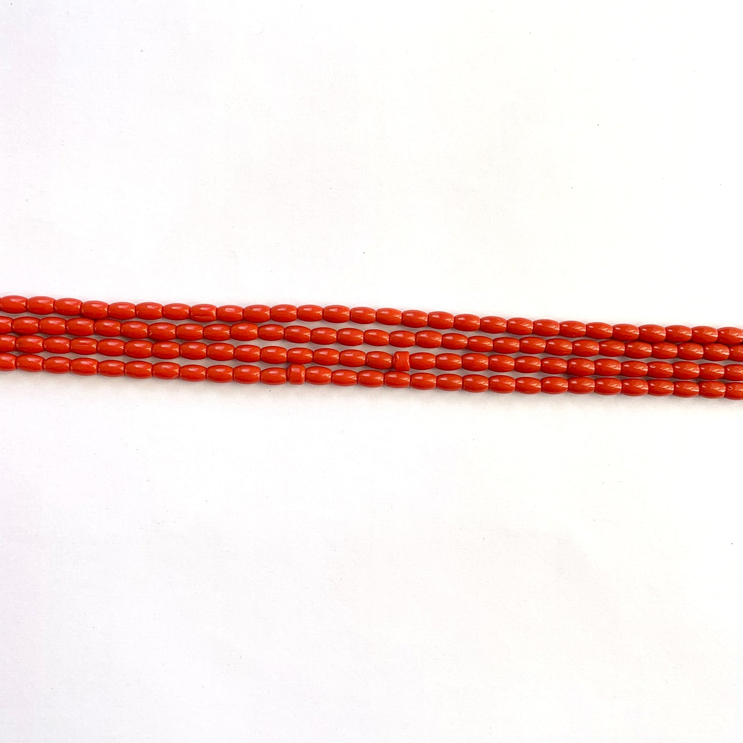 Natural coral texture and hue displayed in a strand of even-sized drum cut beads.